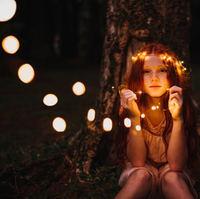 Autumn lights and girl with wreath
